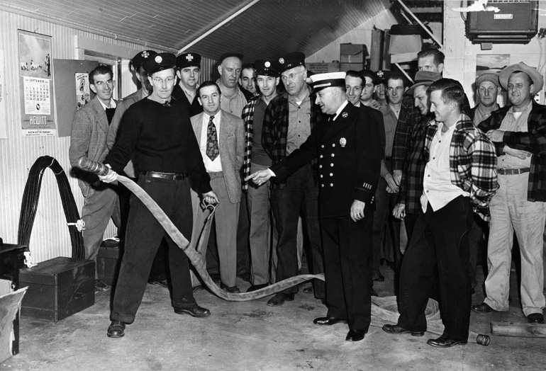 Interior of the old Center Fire Station in 1950, class of instruction 
with Lowell District Captain John Thomas